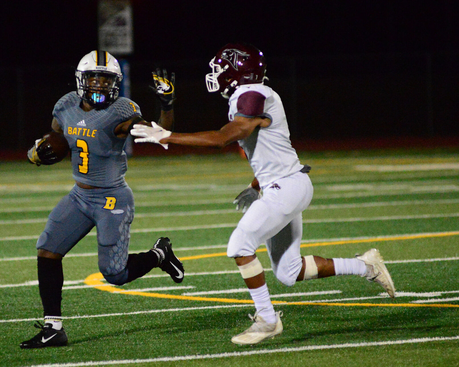 Tay Patrick attempts to stiff arm an opponent on Friday, September 24 at Battle High School in Columbia.
